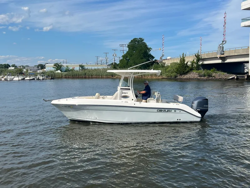 Slide: The Image of 2020 Century 2301 Center Console boat cruising on a calm river under a clear blue sky. - 9