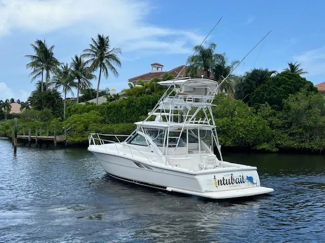 Slide: The Image of 2003 Tiara Yachts 3800 Open cruising on a tropical waterway with palm trees. - 23