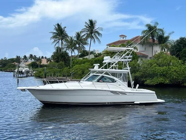 Slide: The Image of 2003 Tiara Yachts 3800 Open cruising on a scenic waterway with palm trees. - 26