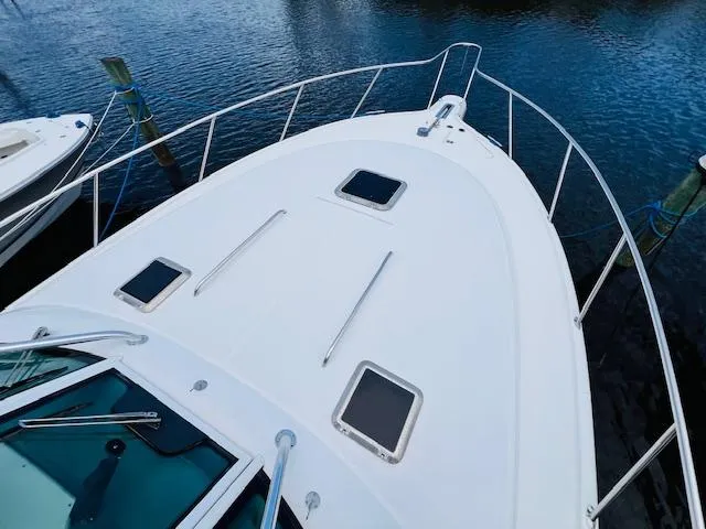 Slide: The Image of Tiara Yachts 3800 Open 2003 model, white deck view, docked on calm water. - 27