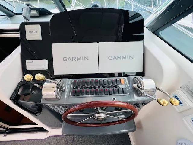 Slide: The Image of Tiara Yachts 3800 Open 2003 helm with Garmin navigation displays and wooden steering wheel. - 39