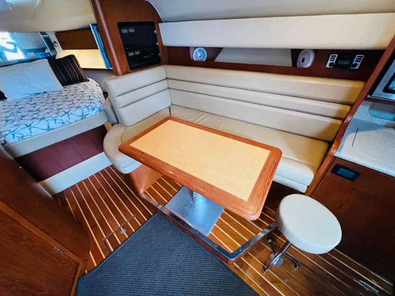Slide: The Image of Interior of 2003 Tiara Yachts 3800 Open with seating and table, wooden flooring. - 45