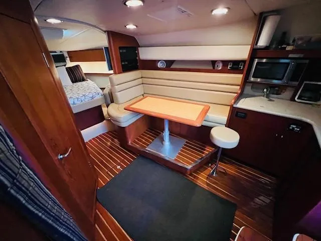 Slide: The Image of Interior of 2003 Tiara Yachts 3800 Open, featuring cozy seating and modern amenities. - 47