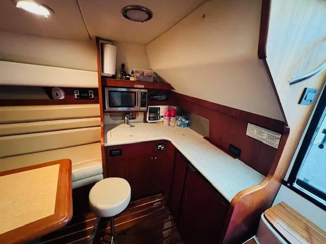 Slide: The Image of 2003 Tiara Yachts 3800 Open interior with kitchenette and seating area. - 48