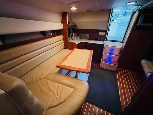 Slide: The Image of Interior of 2003 Tiara Yachts 3800 Open with leather seating and wooden flooring. - 49