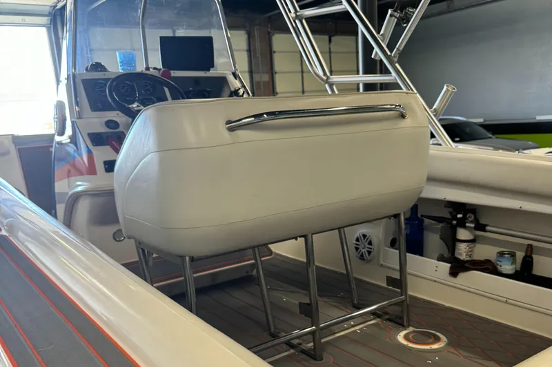 Slide: The Image of 1999 Wellcraft Scarab 302 boat interior with helm seat and control panel. - 12