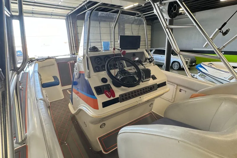 Slide: The Image of 1999 Wellcraft Scarab 302 boat interior with steering console and seating. - 13