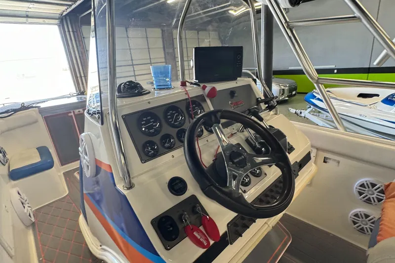Slide: The Image of 1999 Wellcraft Scarab 302 boat cockpit with steering wheel and control panel. - 15