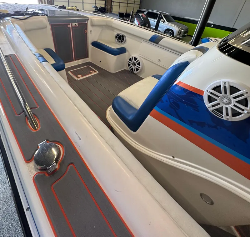 Slide: The Image of 1999 Wellcraft Scarab 302 boat interior with blue and orange accents. - 16