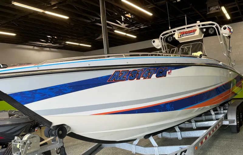 Slide: The Image of 1999 Wellcraft Scarab 302 boat on trailer in indoor showroom. - 5