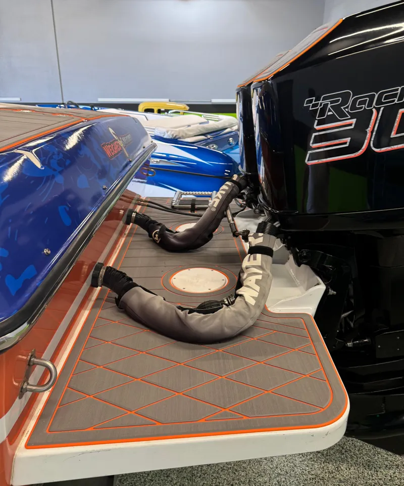 Slide: The Image of 1999 Wellcraft Scarab 302 boat with powerful engine and sleek design. - 7