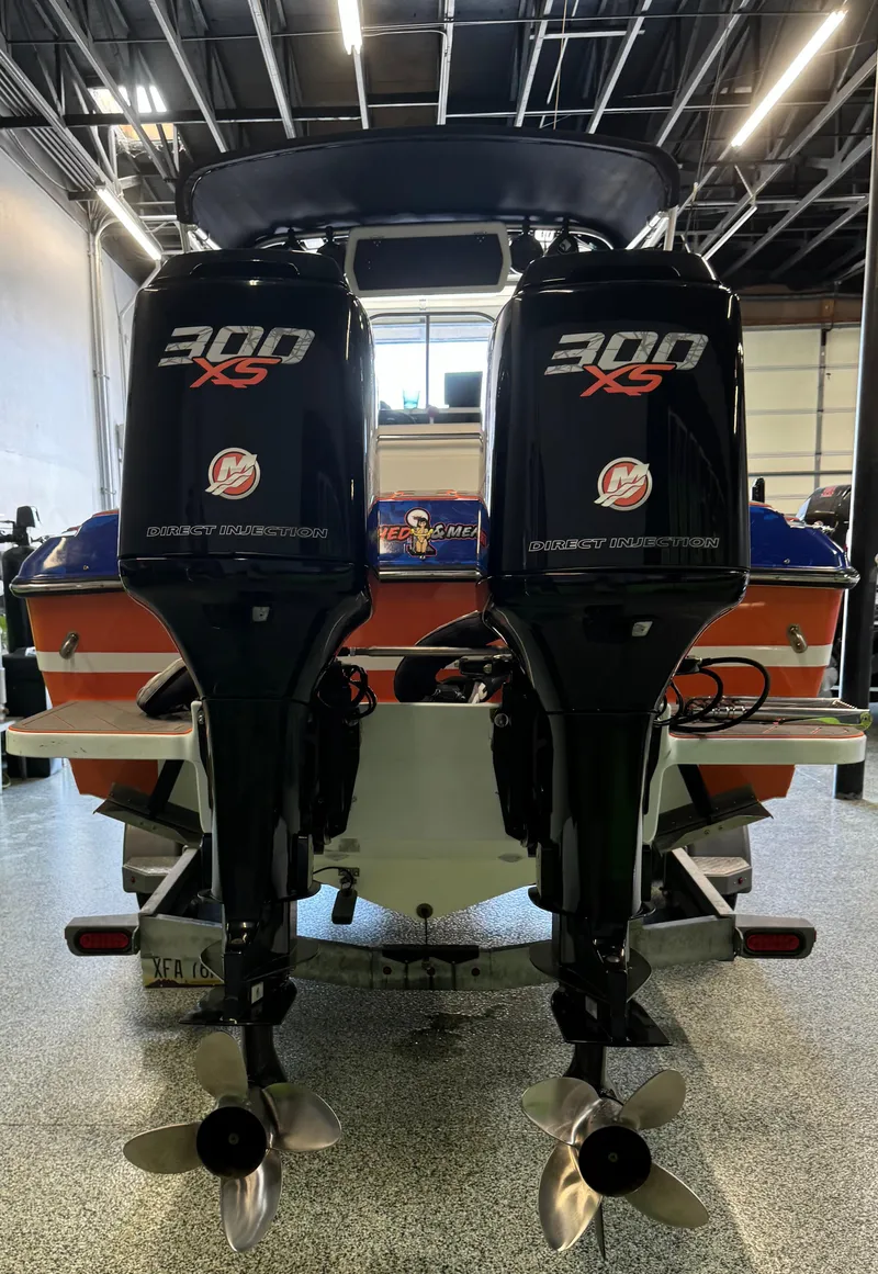 Slide: The Image of 1999 Wellcraft Scarab 302 with twin Mercury 300 XS outboard engines in a garage. - 8