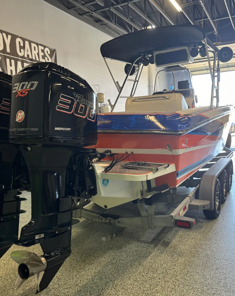 Slide: The Image of 1999 Wellcraft Scarab 302 boat with Mercury 300 XS engines in showroom. - 9