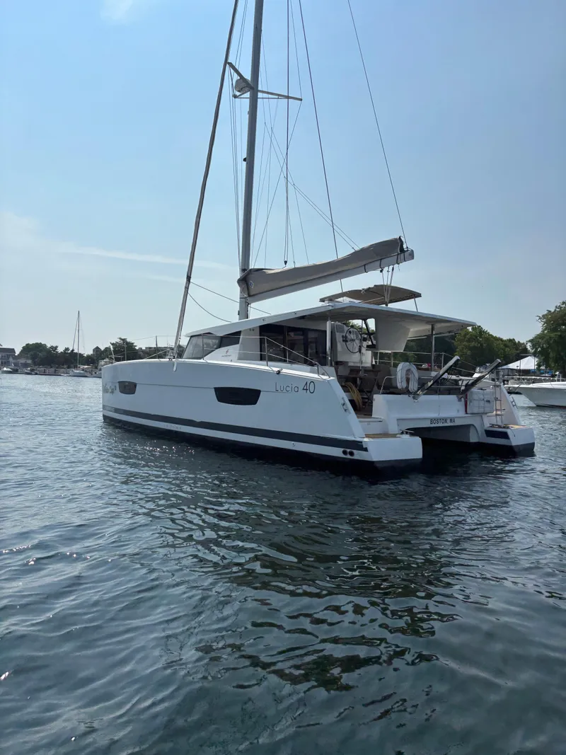 Slide: The Image of 2019 Fountaine Pajot Lucia 40 catamaran sailing on calm waters. - 10