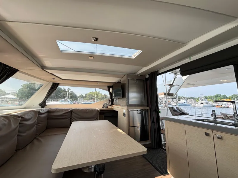 Slide: The Image of Interior of 2019 Fountaine Pajot Lucia 40 catamaran, featuring a spacious dining area and modern kitchen. - 14