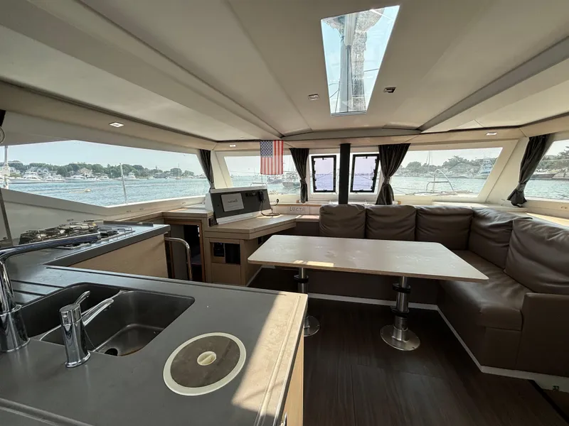 Slide: The Image of Interior of 2019 Fountaine Pajot Lucia 40 catamaran with modern kitchen and seating area. - 15