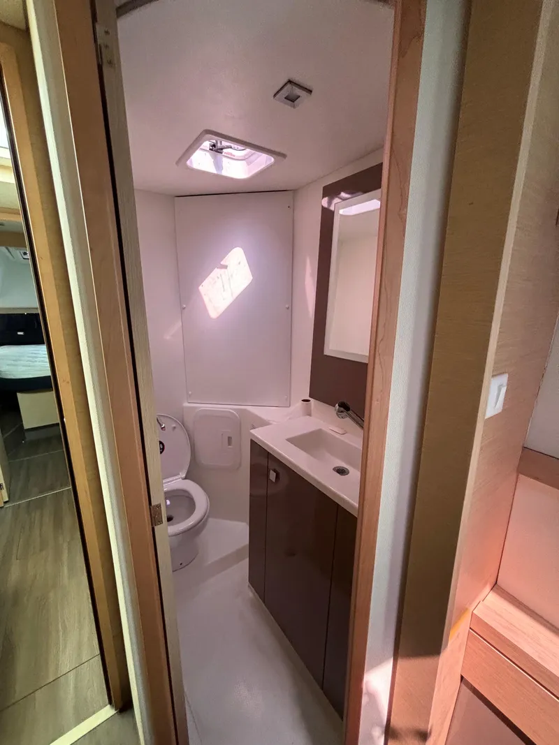 Slide: The Image of 2019 Fountaine Pajot Lucia 40 bathroom with modern fixtures and natural lighting. - 17