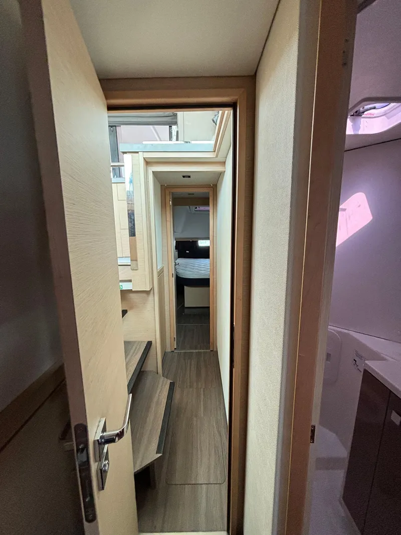 Slide: The Image of Interior hallway of 2019 Fountaine Pajot Lucia 40 catamaran, featuring modern design and wood finishes. - 18