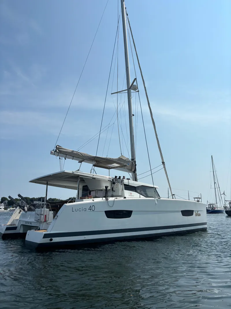 Slide: The Image of 2019 Fountaine Pajot Lucia 40 catamaran sailing on calm waters. - 2