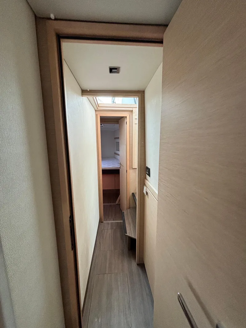 Slide: The Image of Interior hallway of 2019 Fountaine Pajot Lucia 40 catamaran, featuring modern wood finishes. - 22