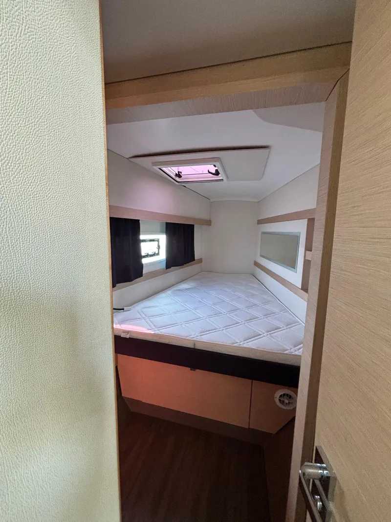 Slide: The Image of Interior cabin of 2019 Fountaine Pajot Lucia 40 catamaran, featuring a cozy bed and skylight. - 24