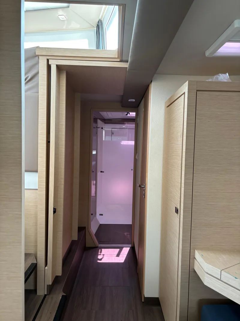 Slide: The Image of Interior hallway of 2019 Fountaine Pajot Lucia 40 catamaran, featuring modern wood finishes. - 26