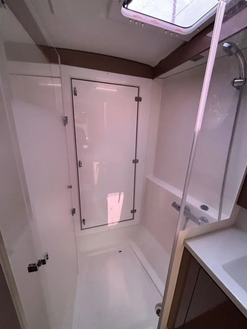 Slide: The Image of 2019 Fountaine Pajot Lucia 40 yacht bathroom with modern shower and sleek design. - 28