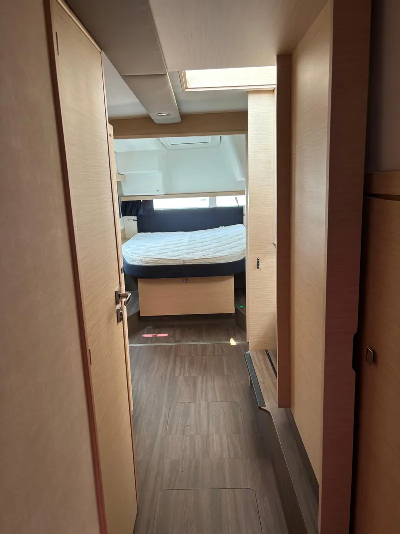 Slide: The Image of Interior of 2019 Fountaine Pajot Lucia 40 catamaran, featuring a cozy cabin with a bed. - 29
