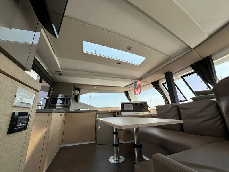 Slide: The Image of Interior of 2019 Fountaine Pajot Lucia 40 catamaran, featuring modern kitchen and seating area. - 31