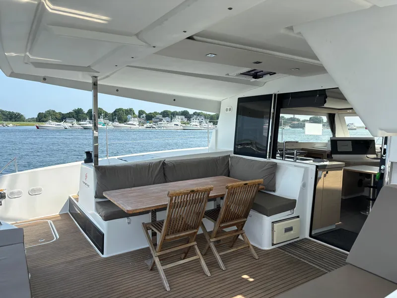 Slide: The Image of Spacious 2019 Fountaine Pajot Lucia 40 catamaran with outdoor seating and scenic water view. - 34