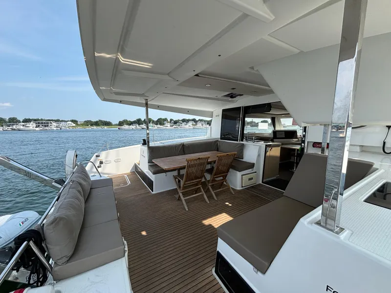 Slide: The Image of Spacious deck of 2019 Fountaine Pajot Lucia 40 catamaran with seating and dining area. - 35