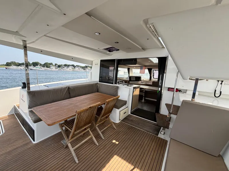 Slide: The Image of 2019 Fountaine Pajot Lucia 40 catamaran interior with dining area and waterfront view. - 37