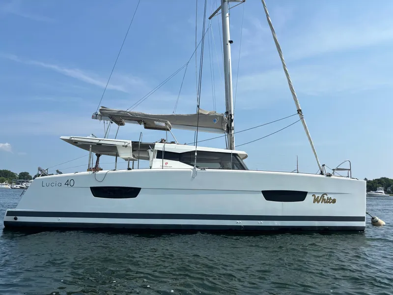 Slide: The Image of 2019 Fountaine Pajot Lucia 40 catamaran sailing on calm waters. - 4
