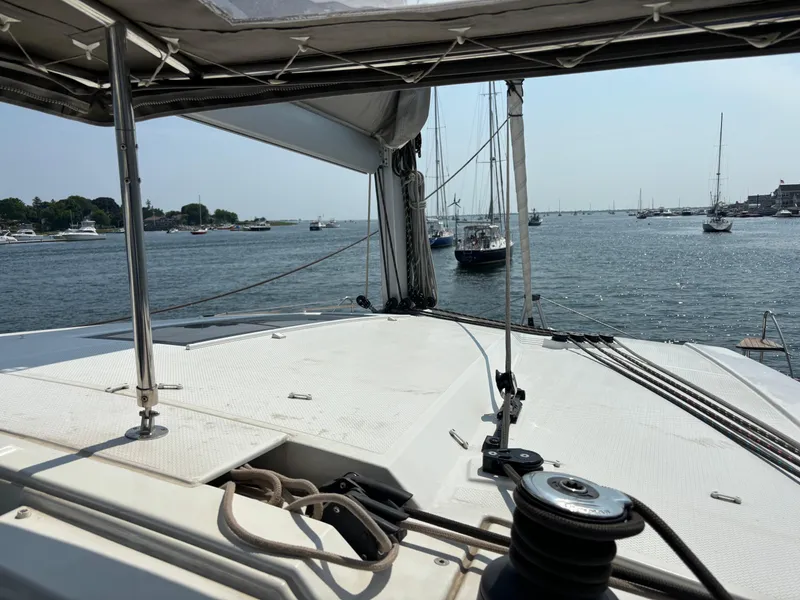 Slide: The Image of Fountaine Pajot Lucia 40 catamaran deck view, sailing in a busy harbor, 2019 model. - 42