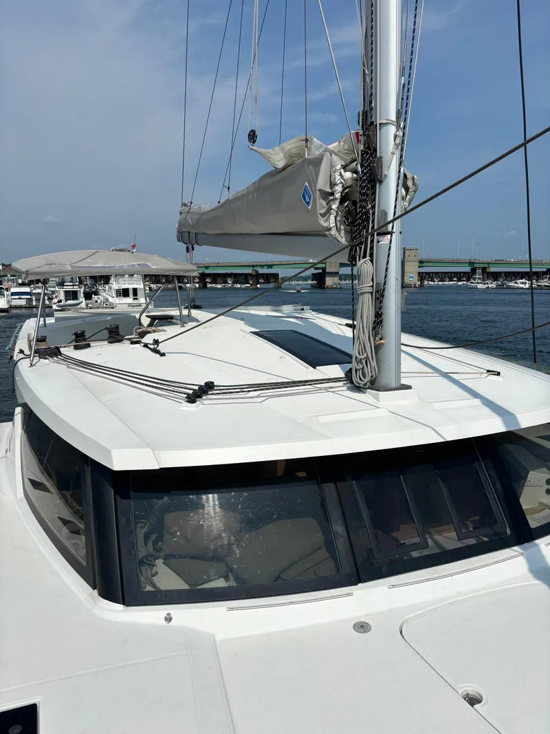 Slide: The Image of 2019 Fountaine Pajot Lucia 40 catamaran docked at marina, sails furled, clear sky. - 48