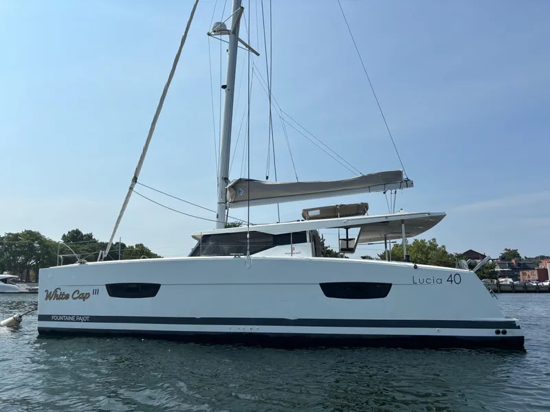 Slide: The Image of 2019 Fountaine Pajot Lucia 40 catamaran on calm water, side view. - 5
