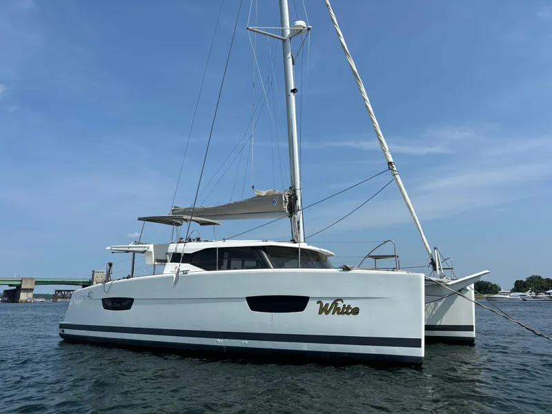 Slide: The Image of 2019 Fountaine Pajot Lucia 40 catamaran sailing on calm waters. - 7