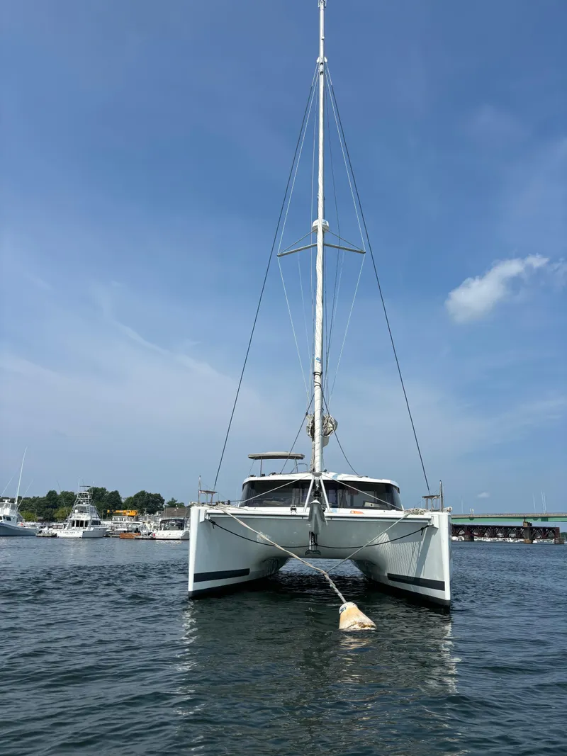 Slide: The Image of 2019 Fountaine Pajot Lucia 40 catamaran on calm water, clear sky background. - 9