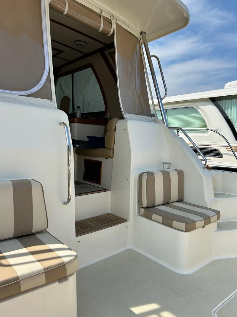 Slide: The Image of 2009 Sabre Hardtop Express boat with striped seating and open cabin entry. - 11
