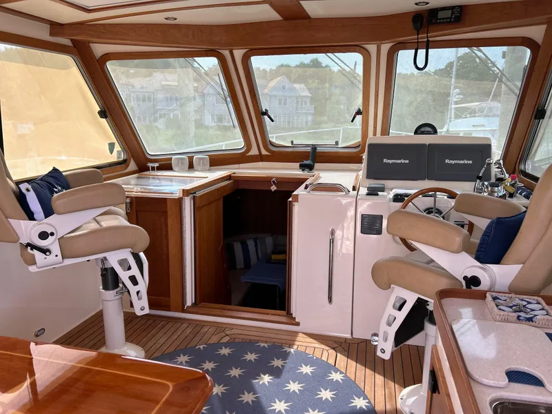 Slide: The Image of 2009 Sabre Hardtop Express interior with helm, seating, and wooden accents. - 14