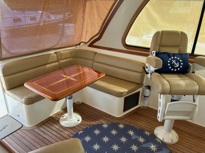 Slide: The Image of 2009 Sabre Hardtop Express interior with tan seating, wooden table, and nautical-themed decor. - 20