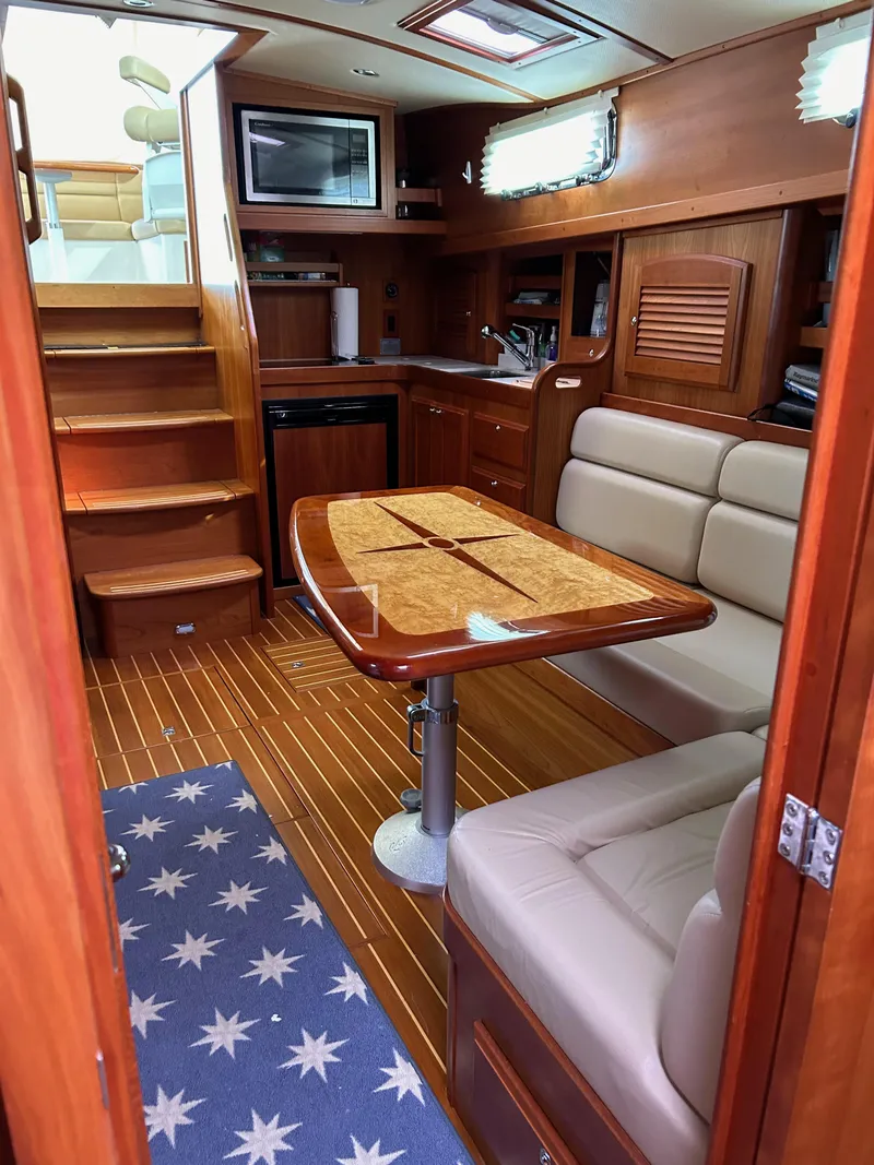 Slide: The Image of 2009 Sabre Hardtop Express interior with wooden dining area and stairs. - 24