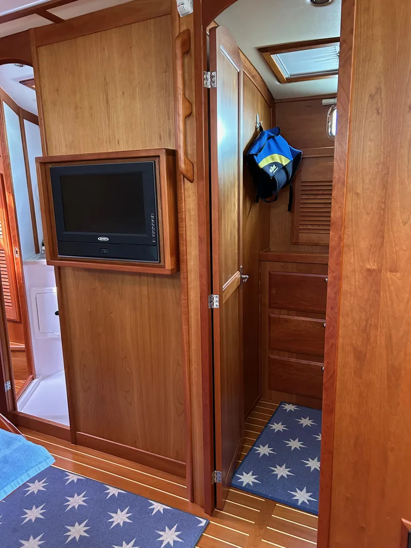 Slide: The Image of 2009 Sabre Hardtop Express interior with wood paneling and mounted TV. - 25