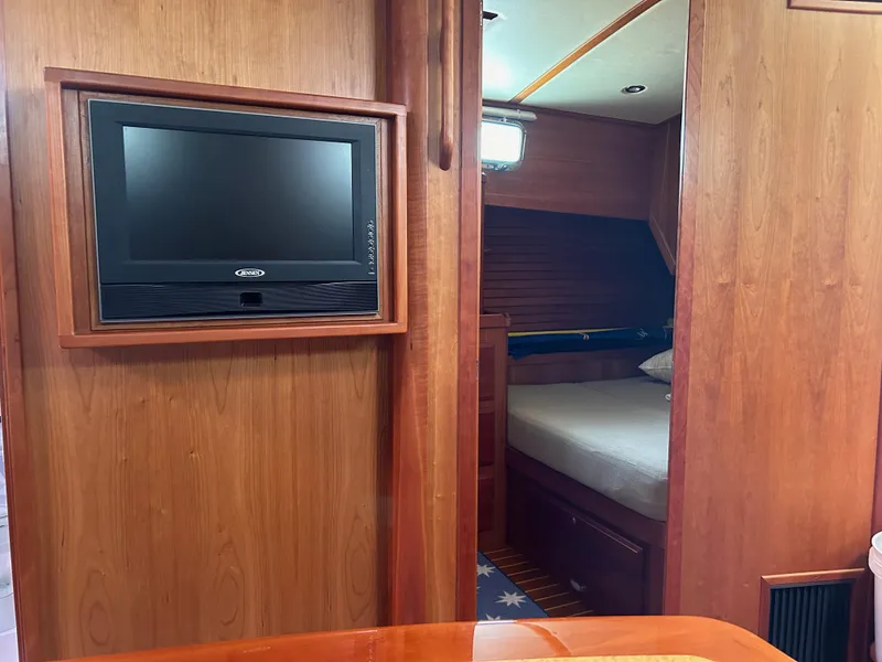 Slide: The Image of 2009 Sabre Hardtop Express interior with wood paneling and mounted TV. - 26