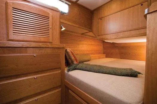 Slide: The Image of 2009 Sabre Hardtop Express cabin interior with wooden finish and cozy bed. - 27