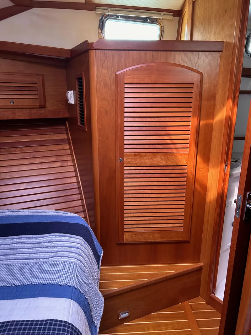 Slide: The Image of 2009 Sabre Hardtop Express cabin interior with wooden paneling and bed. - 33