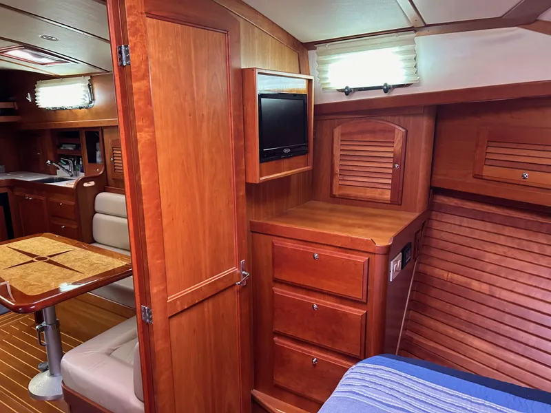 Slide: The Image of Interior of 2009 Sabre Hardtop Express yacht with wood cabinetry and cozy seating area. - 34