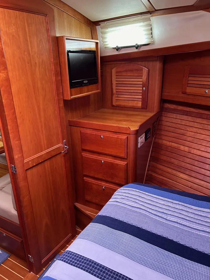 Slide: The Image of 2009 Sabre Hardtop Express cabin with wooden interior and striped bedding. - 35
