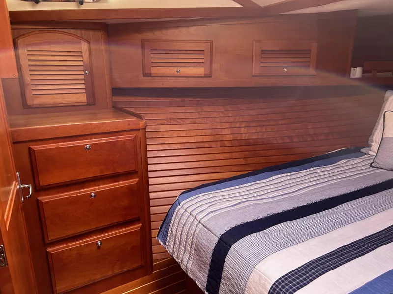 Slide: The Image of 2009 Sabre Hardtop Express cabin with wooden cabinetry and striped bedding. - 36