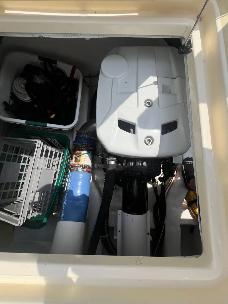 Slide: The Image of Engine compartment of 2009 Sabre Hardtop Express with storage bins and equipment. - 40